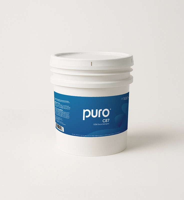 White container of Puro C87 SCBA decontamination detergent with blue label on a light background.