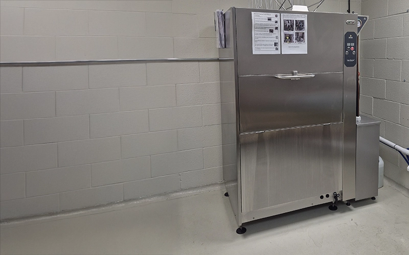 Solo Rescue decontamination washer in a clean industrial setting against a tiled wall.