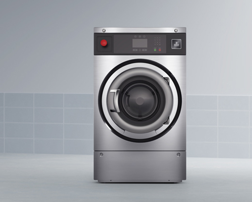 Stainless steel extractor for firefighter turnout gear with front-loading door and control panel, in tiled room.