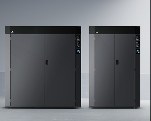 Two dark drying cabinets side by side in tiled room; both feature top control panels and sleek industrial design.